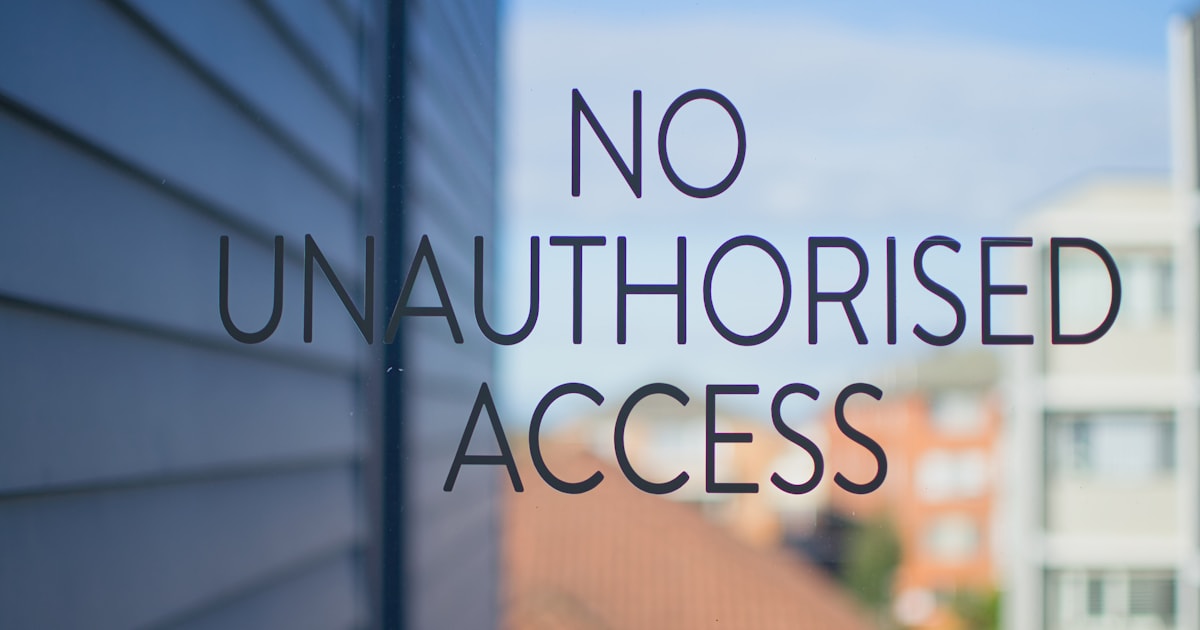 No unauthorised access notice on a glass entrance