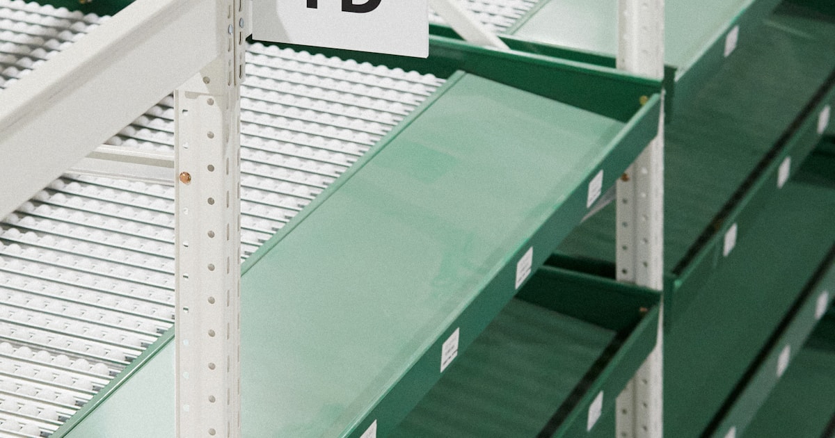 Empty green warehouse shelving prepared for inventory