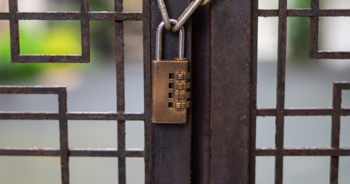 Locked gate secured with a chain and padlock