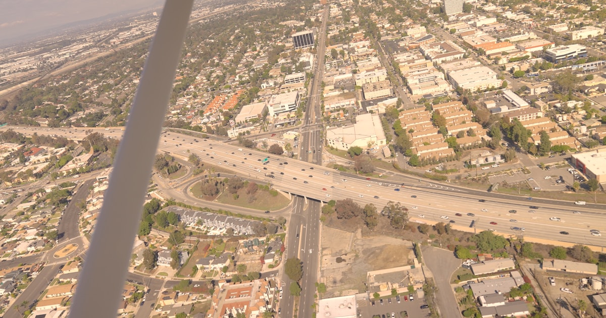 Aerial view of a highway interchange crossing an urban area