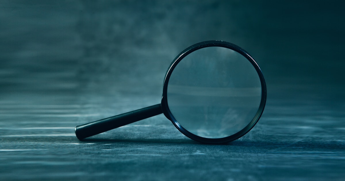 Magnifying glass resting on a dark textured surface