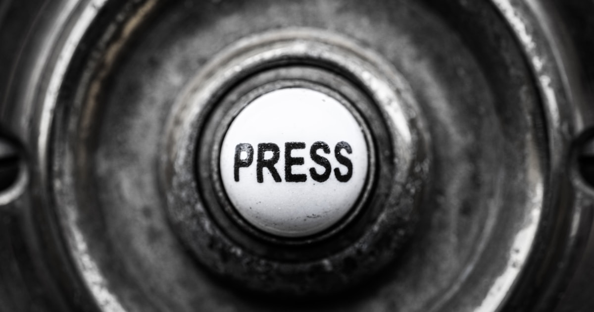 Close-up of a mechanical button labeled PRESS