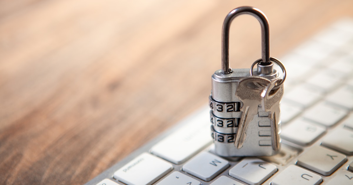 Padlock and keys resting on a computer keyboard