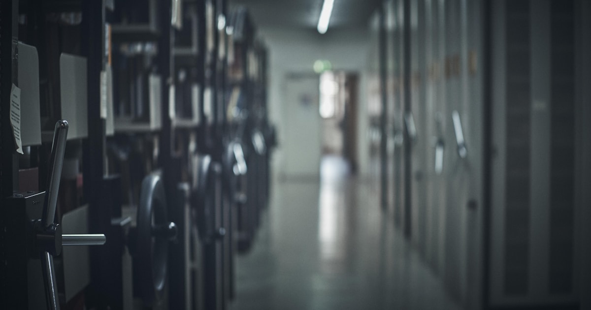 Long archival corridor lined with rows of storage cabinets