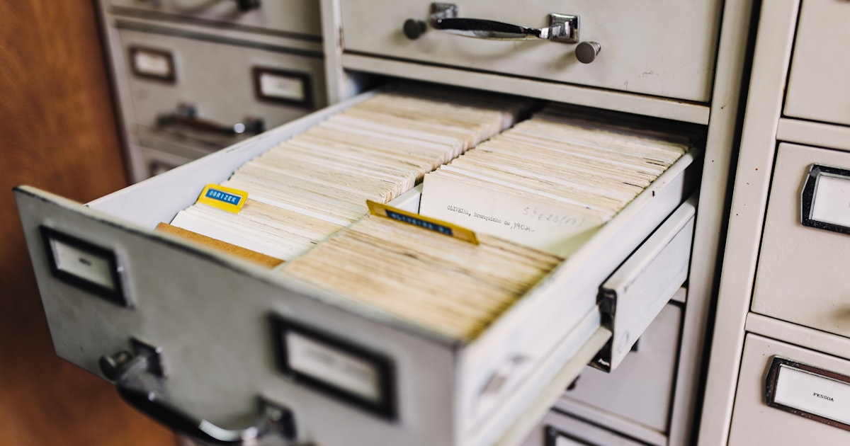 Open filing cabinet drawer filled with organized paper records