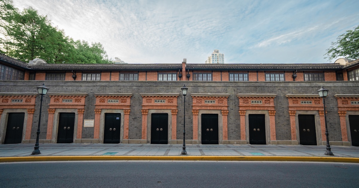 Row of nearly identical doors along a brick building facade