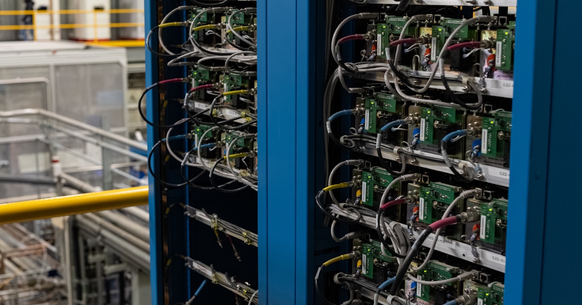 Two racks of computing equipment and dense cabling in a technical facility