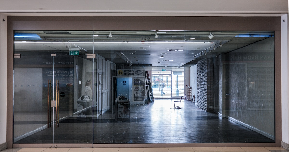 Empty storefront with glass doors and no merchandise